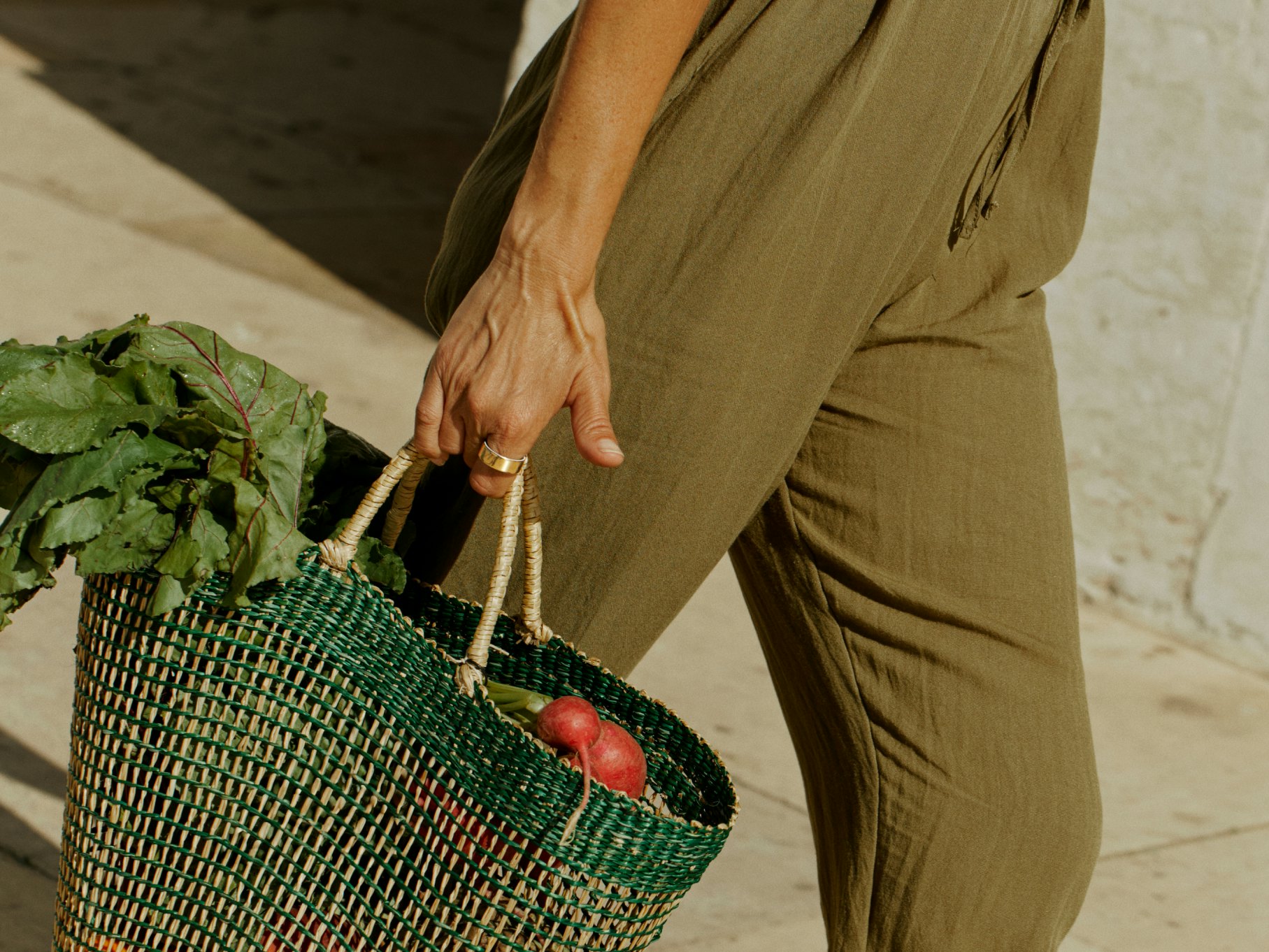 Hand carrying bag wearing an Oura Ring