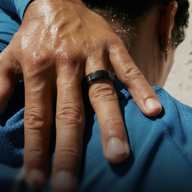 Close up of a person's hand with a Black Oura Ring 4 on their finger